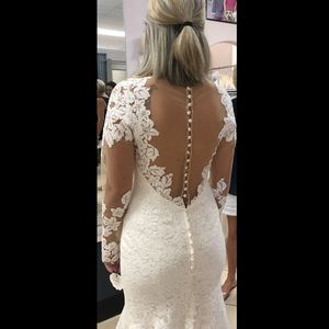 Brand new. Never worn size 12 wedding dress